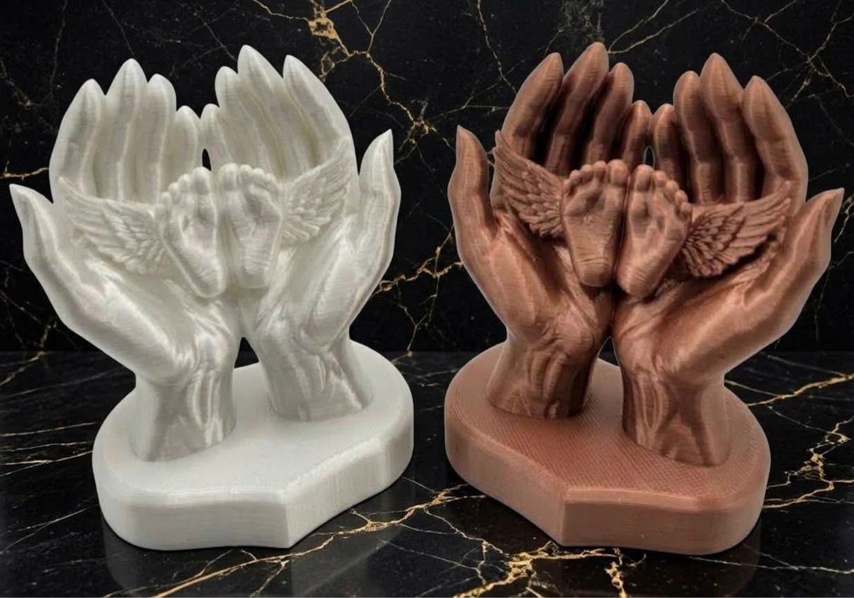 Small memorial hands holding baby feet